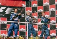 Jacques Villeneuve (C) of Canada sprays champagne after winning the Hungarian Grand Prix August 1997 with second-placed Damon Hill (L) and third-placed Johnny Herbert: Getty Images